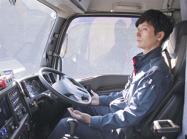 いすゞ自動車のトラックの運転席。運転手がハンドルに手を触れることなく自動走行した=18日午前、北海道むかわ町